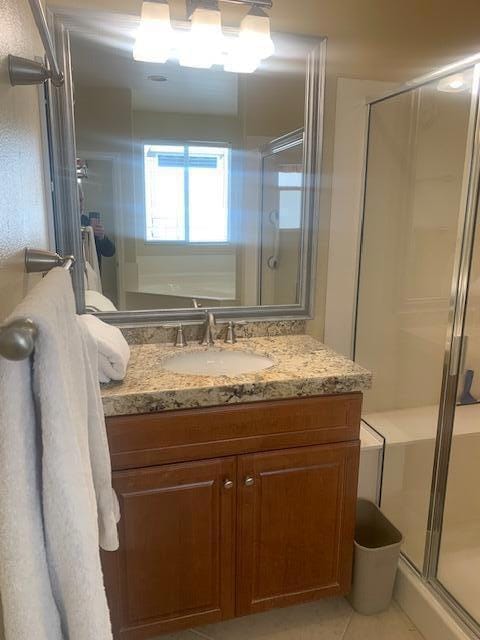 bathroom with vanity, tile patterned floors, and a shower with shower door