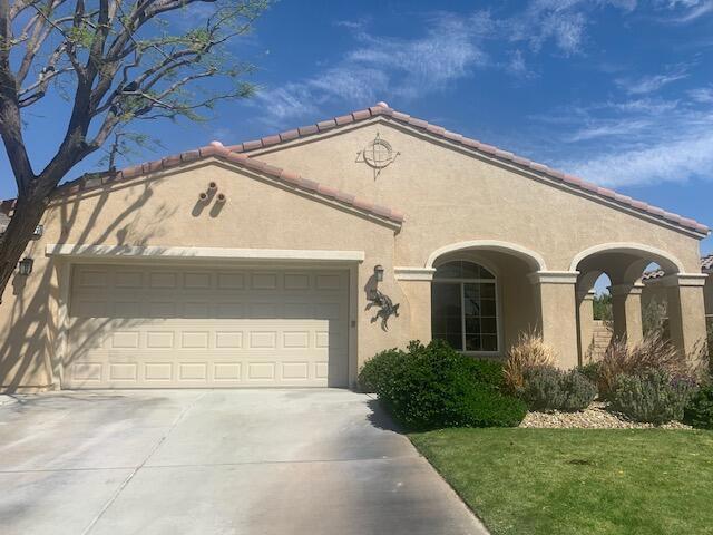 view of front of home with a garage and a front lawn