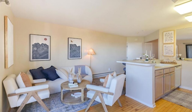 living room featuring sink, a baseboard radiator, and light hardwood / wood-style floors