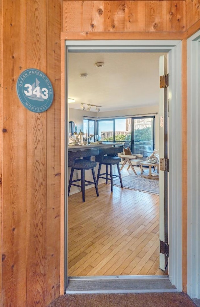 interior space with hardwood / wood-style floors and wooden walls