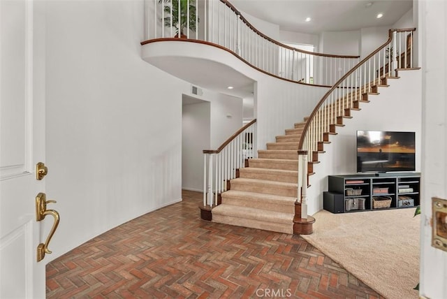 foyer featuring a towering ceiling