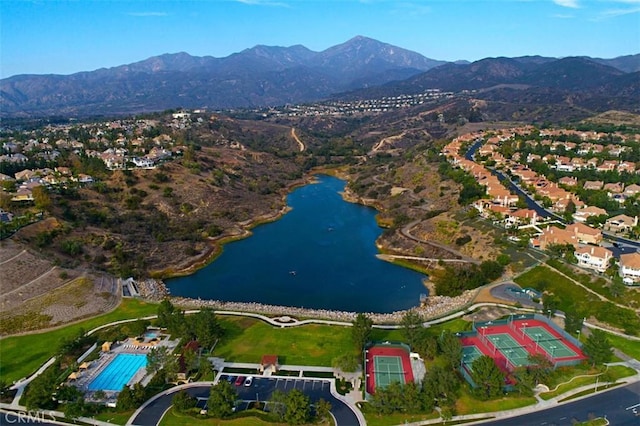 drone / aerial view with a water and mountain view