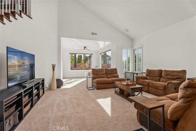 living room featuring carpet floors and high vaulted ceiling