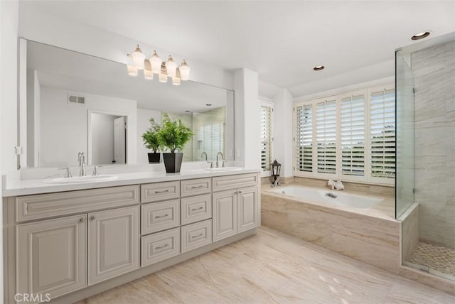 bathroom with vanity and independent shower and bath