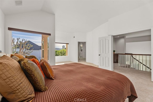 bedroom featuring vaulted ceiling and light carpet