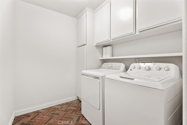 laundry area with washer and clothes dryer and cabinets