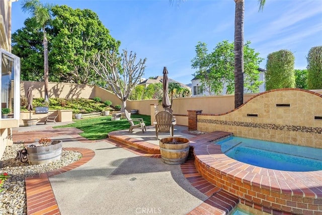 exterior space featuring an in ground hot tub