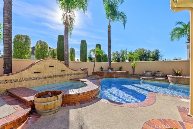 view of pool with an in ground hot tub