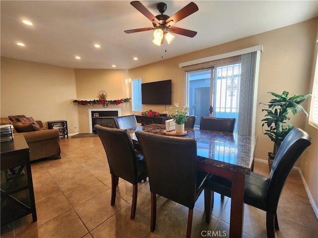 dining space featuring ceiling fan and light tile patterned flooring