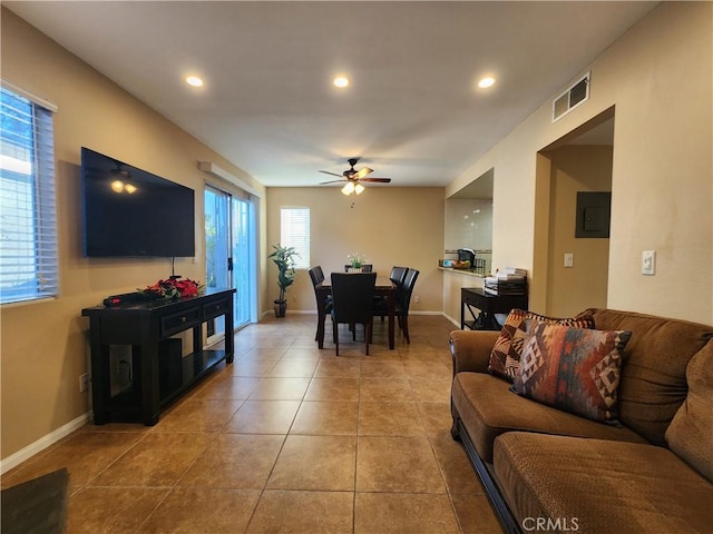 tiled living room featuring ceiling fan