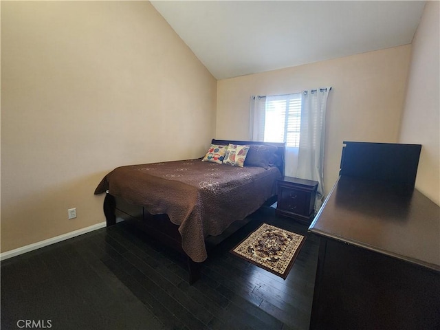 bedroom with wood-type flooring and vaulted ceiling