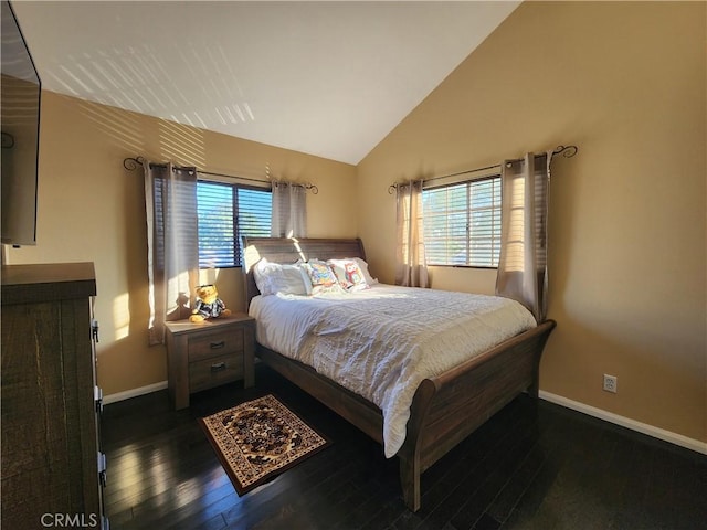 bedroom featuring multiple windows, dark hardwood / wood-style flooring, and lofted ceiling