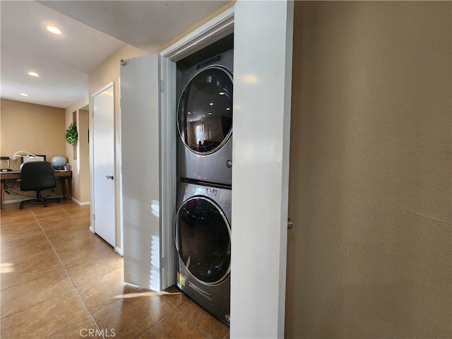 washroom featuring tile patterned flooring and stacked washing maching and dryer