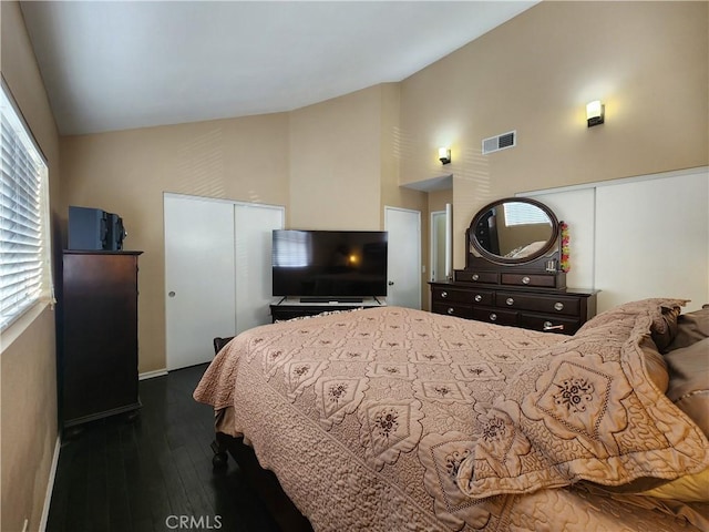 bedroom featuring dark wood-type flooring and vaulted ceiling