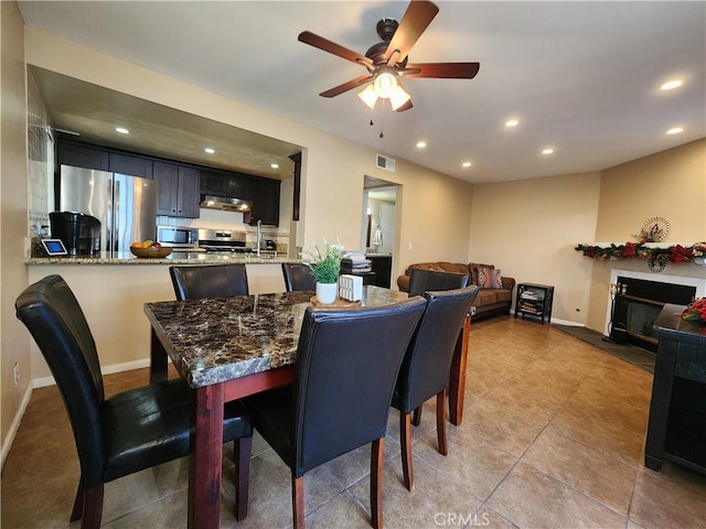 dining area featuring light tile patterned floors and ceiling fan