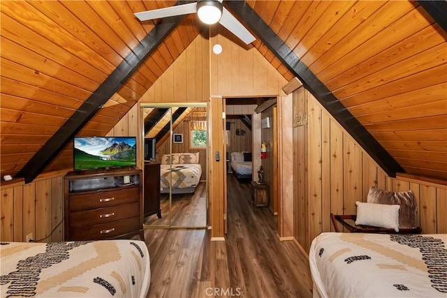 unfurnished bedroom with lofted ceiling with beams, wooden walls, ceiling fan, dark hardwood / wood-style floors, and wood ceiling