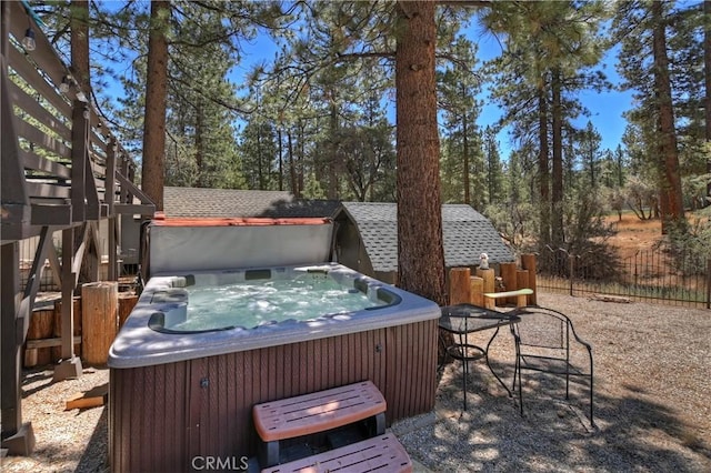 wooden deck featuring a hot tub