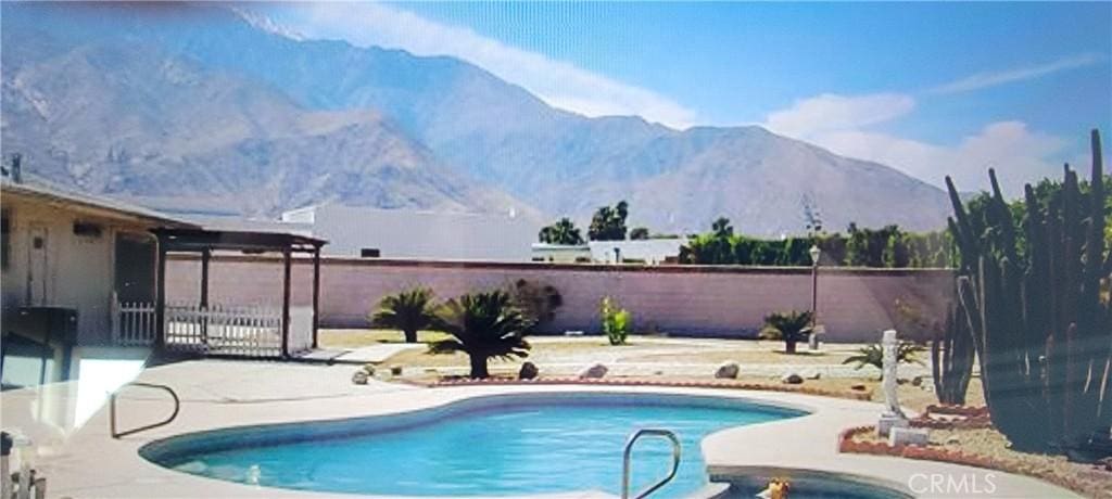 view of swimming pool with a mountain view and a patio