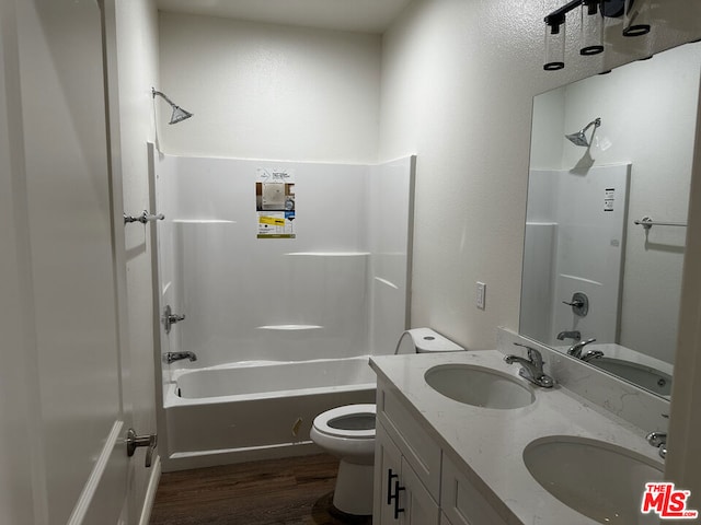 full bathroom with vanity, hardwood / wood-style flooring, toilet, and tub / shower combination