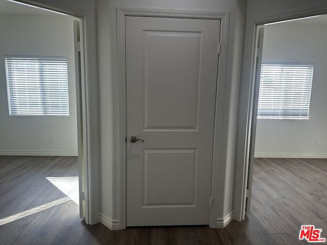 hallway with a healthy amount of sunlight and light hardwood / wood-style floors