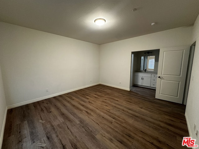 unfurnished bedroom featuring dark wood-type flooring