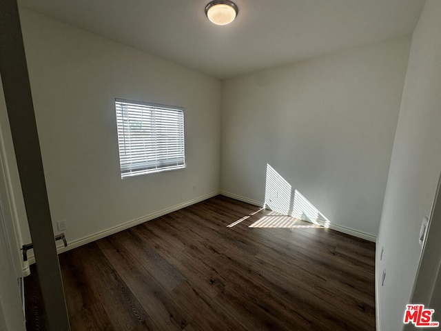 empty room featuring dark hardwood / wood-style flooring