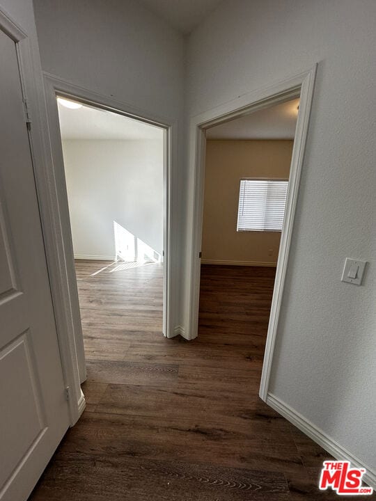 corridor featuring dark hardwood / wood-style floors