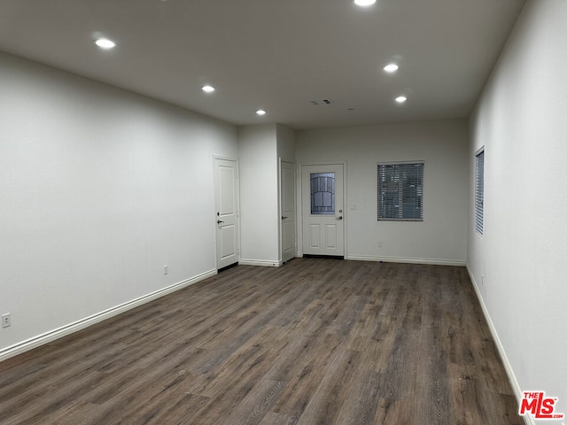 unfurnished room featuring dark wood-type flooring