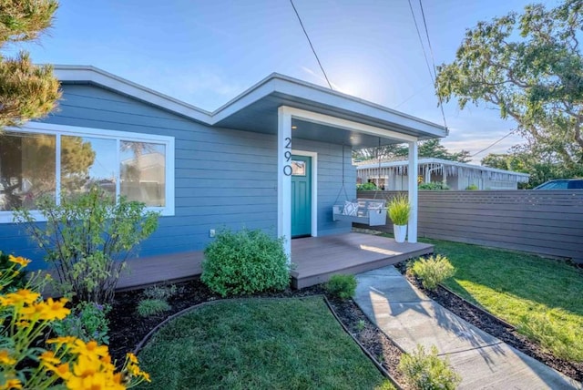 doorway to property featuring a yard