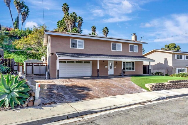 front facade with a front yard and a garage