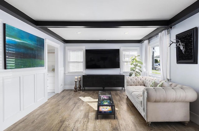 living room featuring beamed ceiling and hardwood / wood-style floors