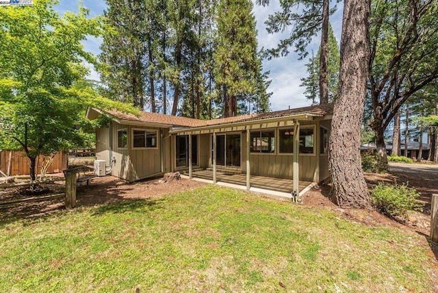 rear view of property featuring a lawn and a patio