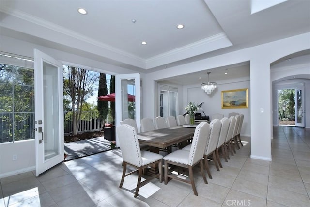 dining space featuring light tile patterned floors, an inviting chandelier, and crown molding