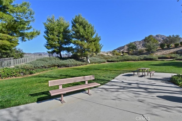 view of community featuring a lawn and a mountain view