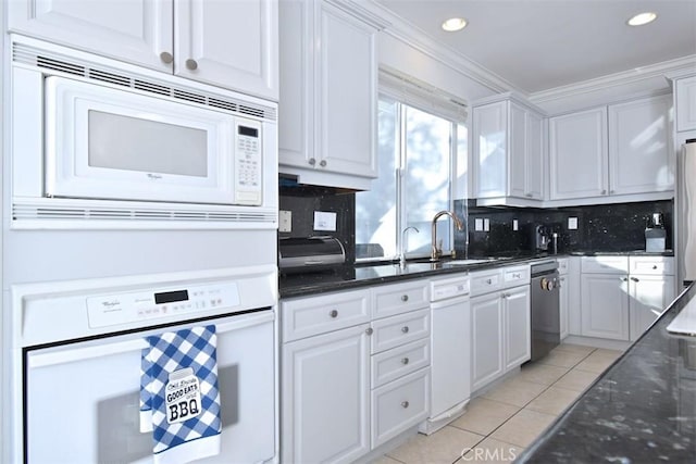 kitchen with white cabinets, white appliances, decorative backsplash, light tile patterned floors, and ornamental molding