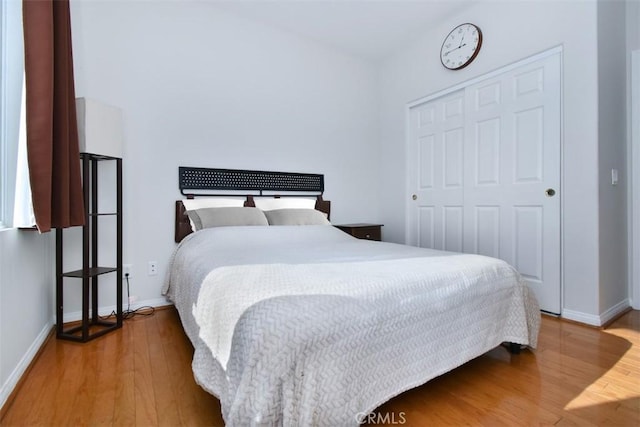 bedroom with a closet and hardwood / wood-style floors