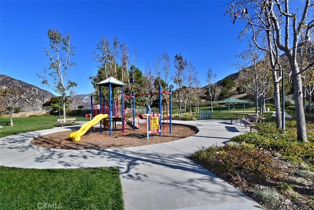 view of jungle gym featuring a mountain view