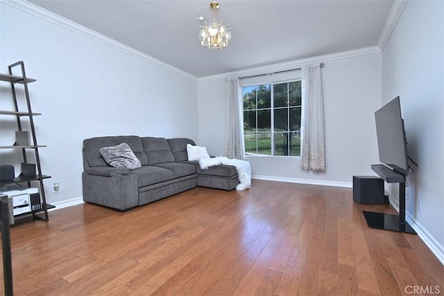 living room featuring hardwood / wood-style floors, a notable chandelier, and ornamental molding