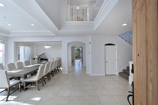 tiled dining room with a notable chandelier