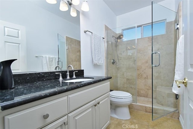 bathroom with toilet, tile patterned flooring, vanity, and walk in shower