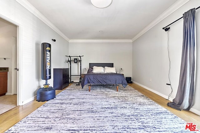 bedroom with hardwood / wood-style flooring and crown molding