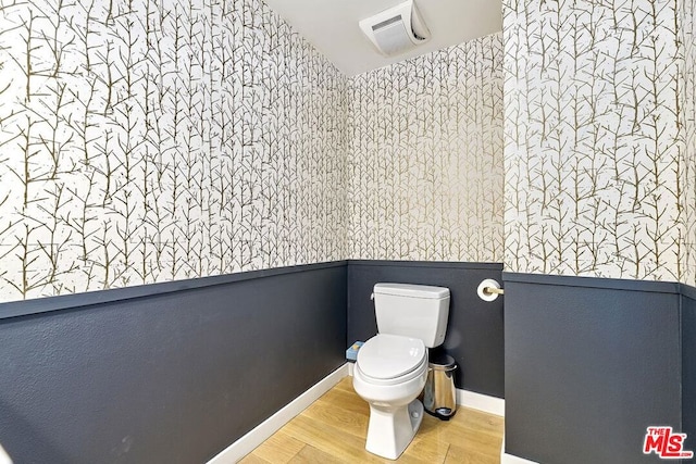 bathroom featuring hardwood / wood-style floors and toilet