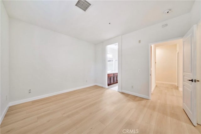 spare room with light hardwood / wood-style flooring