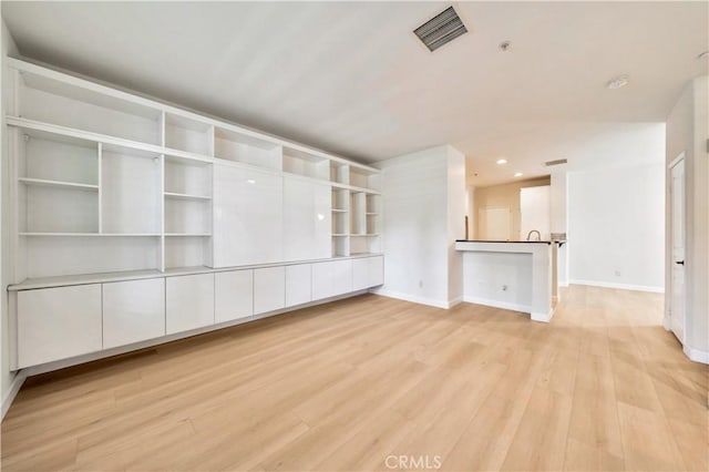 unfurnished living room featuring light wood-type flooring