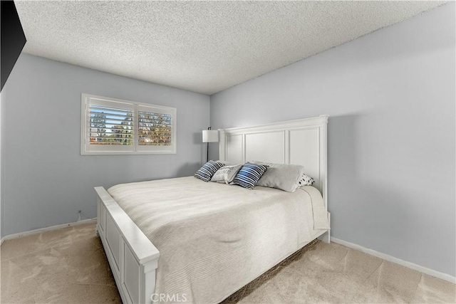 carpeted bedroom featuring a textured ceiling