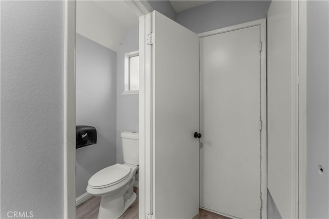 bathroom featuring hardwood / wood-style flooring and toilet