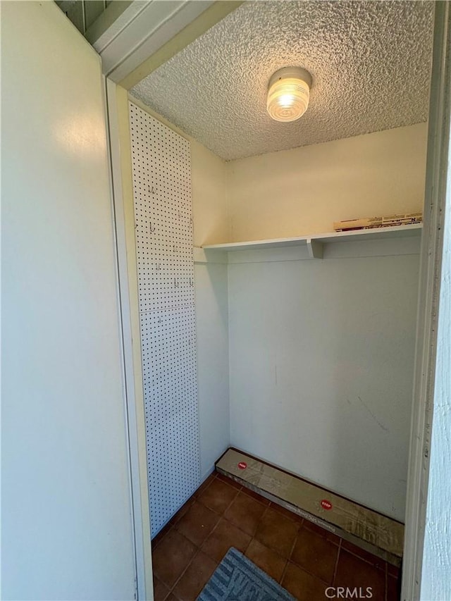 walk in closet with tile patterned floors