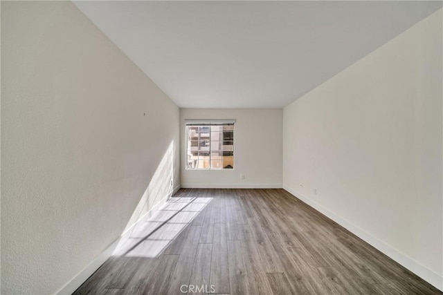 empty room featuring hardwood / wood-style flooring