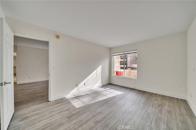 spare room with light wood-type flooring