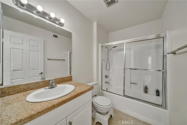 full bathroom featuring tile patterned flooring, vanity, toilet, and combined bath / shower with glass door